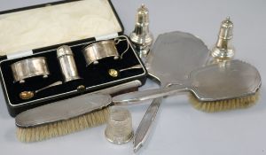 Mixed silver items including mirror and brush set, case condiment set, peppers etc.