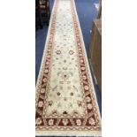 A Persian cream ground runner 506 x 79cm