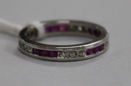 A white metal, ruby and diamond set full eternity ring, size L.