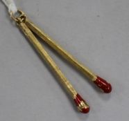 A 9ct gold and red enamel "twin matchstick" pendant, enamel a.f. 40mm.From the estate of the late