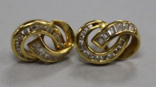 A pair of 18ct gold and diamond scrolling entwined earstuds.From the estate of the late Sheila