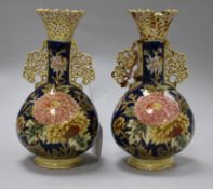 A pair of Zsolnay Pecs reticulated vases, floral-decorated on a blue ground and heightened in gilt