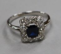 A 20th century 18ct white gold, sapphire and diamond tablet cluster ring, size L.