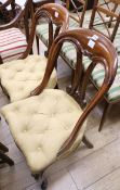 A pair of Victorian mahogany dining chairs, with yellow buttoned upholstered seats