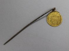 A George VI Gold coin mounted on a pin
