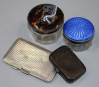 A George V tortoiseshell and silver mounted toilet jar, a silver cigarette case, a silver vesta case