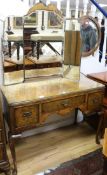 A burr walnut dressing table, fitted three small drawers, on cabriole legs W.106cm