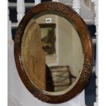 A circular hammered copper framed wall mirror, with bevelled plate W.53cm