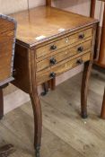 A Regency mahogany drop-flap work table, ebony line-inlaid, fitted three drawers, raised on sabre