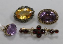 An early 20th century amethyst and split pearl brooch, an amethyst "spinning" fob pendant and two