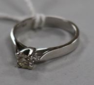 A modern 18ct white gold and claw set solitaire diamond ring, size O.