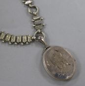 A Victorian silver oval locket with overlaid yellow metal floral decoration, on an ornate white