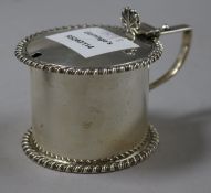 A late Victorian silver drum shaped mustard pot.