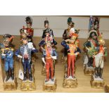 A set of twelve Capo di Monte Napoleonic Wars military figures and a figure of an Old Guard standard