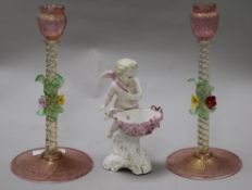 A pair of Venetian glass candlesticks and a Continental porcelain cherub