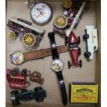 A quantity of toy cars, novelty watches and a Mickey Mouse stopwatch