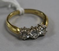 An 18ct gold and three stone diamond ring, size M.
