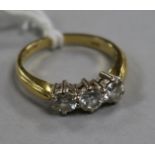 An 18ct gold and three stone diamond ring, size M.
