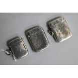 Three assorted silver vesta cases.