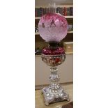 A silver plated and cranberry glass oil lamp 62cm