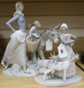 A Lladro large figure group, woman with child and donkey and another of a woman with three goats