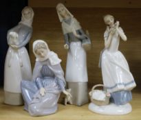 Two Lladro figures, girl with sheep and girl with puppy and bread basket and two other figures,