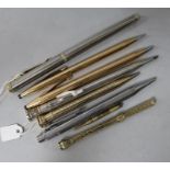 A group of pens and pencils, including a gold encased propelling pencil