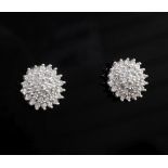 A pair of 18ct white gold and diamond cluster ear studs, of stepped circular form, diameter 11.5mm.