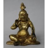 A gilt bronze seated figure of a deity