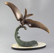 Lucien Gibert. A patinated bronze model of a seagull flying over a wave, signed Trebig, height