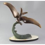 Lucien Gibert. A patinated bronze model of a seagull flying over a wave, signed Trebig, height