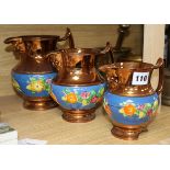 A set of three Victorian copper lustre jugs