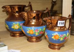 A set of three Victorian copper lustre jugs