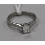 A modern platinum and claw set solitaire baguette cut diamond ring, size L.