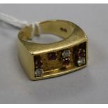 An early 1970's 18ct gold, ruby and diamond set ring, indistinct maker's mark, size K.