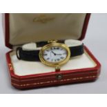 A lady's 18ct gold Cartier oval cased wrist watch, with Cartier box.