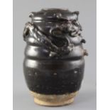 A Chinese Henan ware black glazed jar, Song dynasty, the ribbed body modelled in relief with an