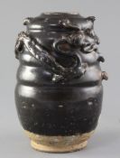 A Chinese Henan ware black glazed jar, Song dynasty, the ribbed body modelled in relief with an