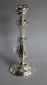 A modern silver candlestick with foliate decoration, W.I. Broadway & Co, Birmingham, 1974, weighted,