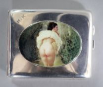 A George V silver cigarette case with later enamelled oval plaque of a lady on a windy day (with