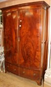 A George III style banded mahogany two door bowfronted wardrobe W.138cm