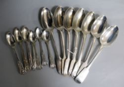 Three William IV silver fiddle, thread and shell table spoons, four later fiddle pattern tablespoons