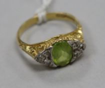 An 18ct gold, peridot and diamond cluster ring, size N.