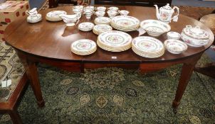 An Edwardian inlaid mahogany oval topped dining table 191cm