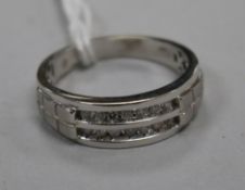 A modern 10ct white gold and two row channel set diamond half hoop ring, size W.