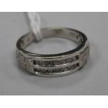 A modern 10ct white gold and two row channel set diamond half hoop ring, size W.