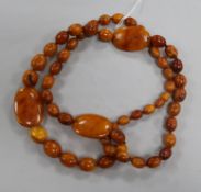 A single strand amber bead necklace, strung with oval and flat beads, gross weight, 109 grams, 98