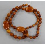 A single strand amber bead necklace, strung with oval and flat beads, gross weight, 109 grams, 98