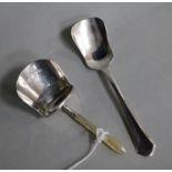 A Georgian silver caddy spoon, Joseph Wilmore, Birmingham, 1810 and a later 1930's silver caddy
