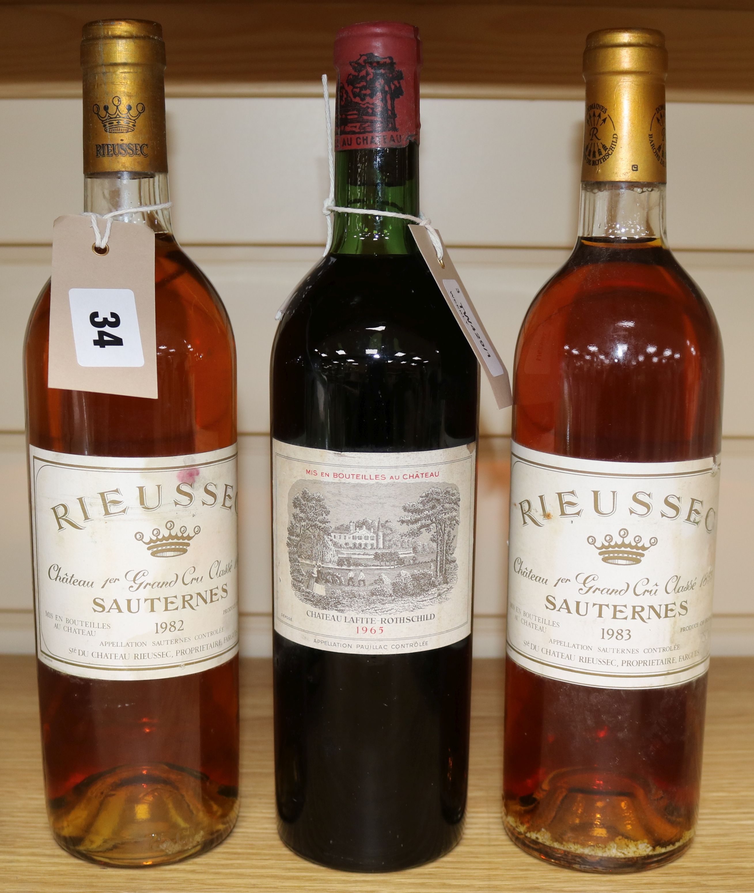 A bottle of Chateau Lafite Rothschild 1965 and and two bottles of Chateau Rieussec Sauternes Premier